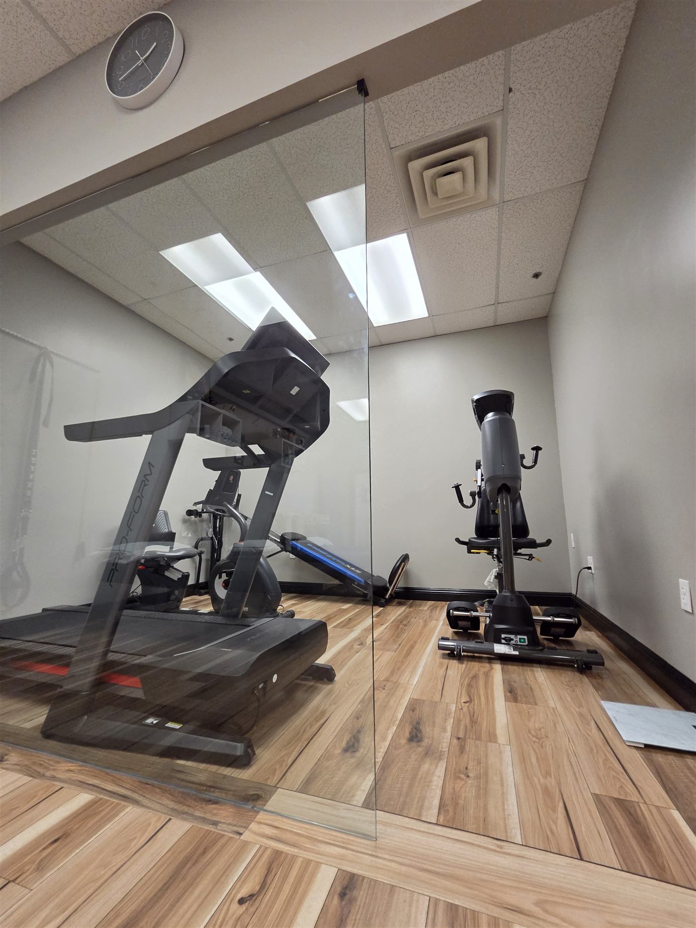 Cardio room with treadmill and exercise bike