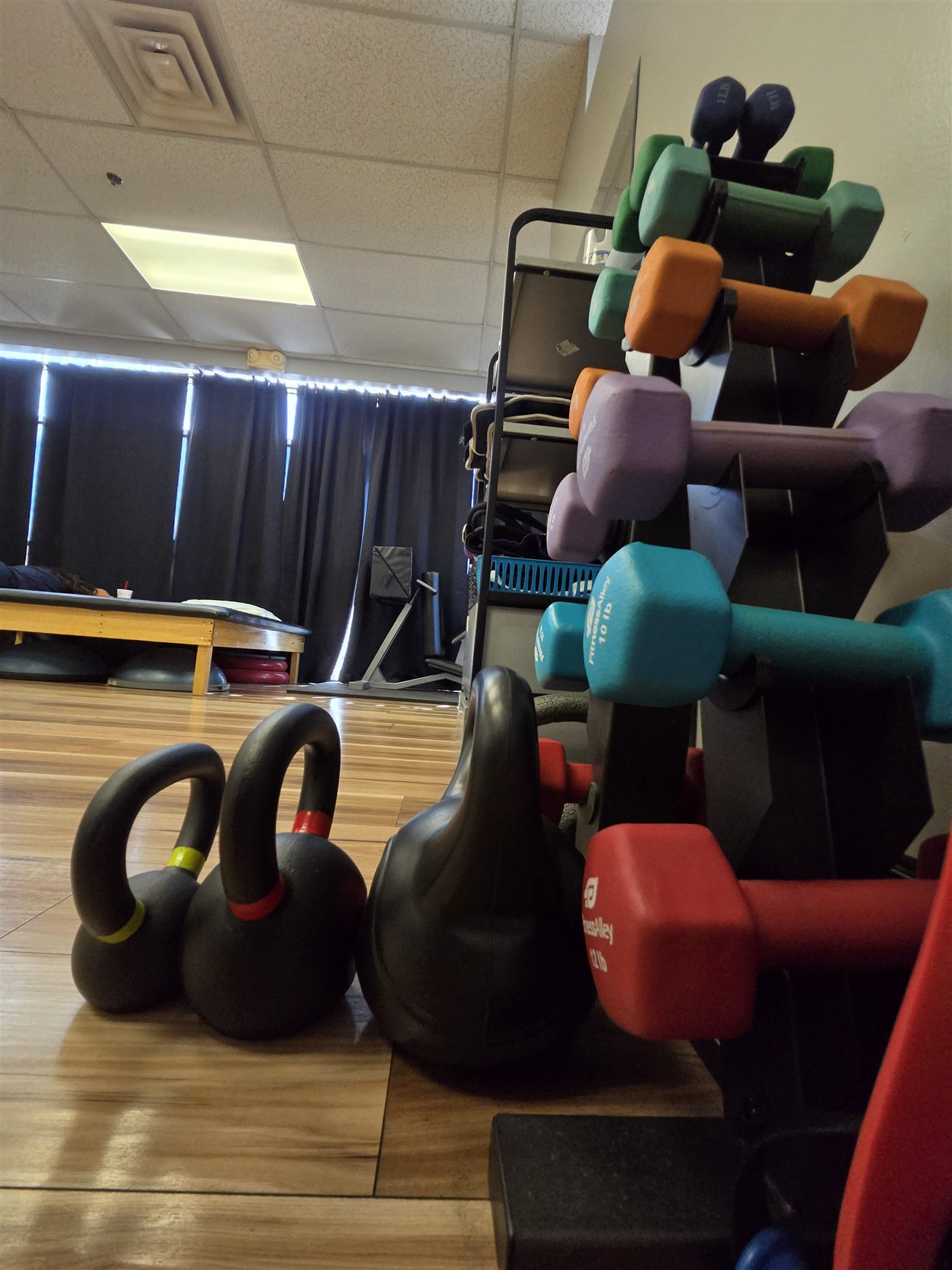 Kettlebells and dumbbells on the Synergy gym floor